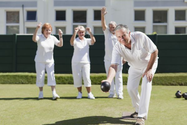 group of elderly people playing bowls